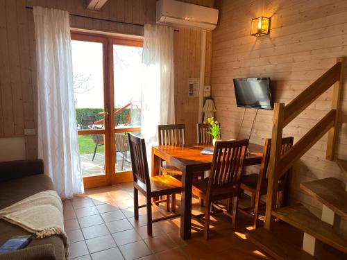 a dining room with a table and chairs and a television at Casa Anna in Vesta