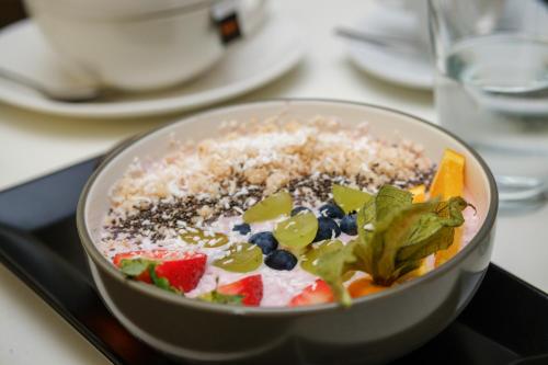 a bowl of food with fruit and rice on a table at Křišťanka - kouzelné apartmány in Prachatice