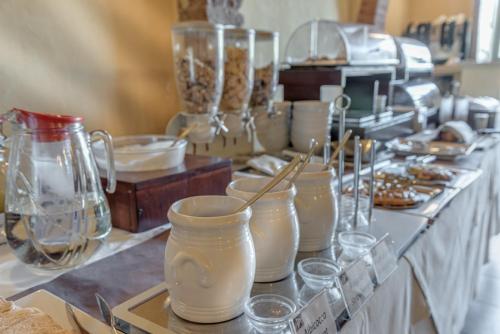 a counter with many glass vases on a table at Hotel Palazzo di Valli in Siena