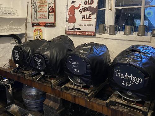 a group of black bags sitting on a table at Kings Head Low House in Laxfield