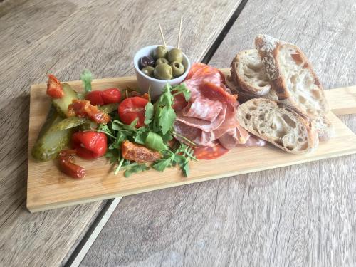 a plate of food with meat and bread and vegetables at Kings Head Low House in Laxfield