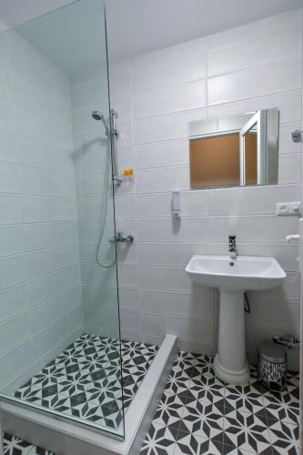 a bathroom with a sink and a shower at Euro Hotel Kutaisi in Kutaisi