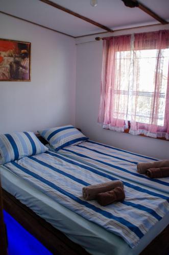 a bedroom with a bed with two towels on it at Midana Vrdnik in Vrdnik