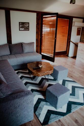 a living room with a couch and a coffee table at Midana Vrdnik in Vrdnik