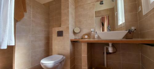 a bathroom with a toilet and a sink at La maison de Malaurie in Gruissan