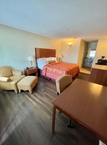 a hotel room with a bed and a table at Riviera Inn and Suites in Riviera
