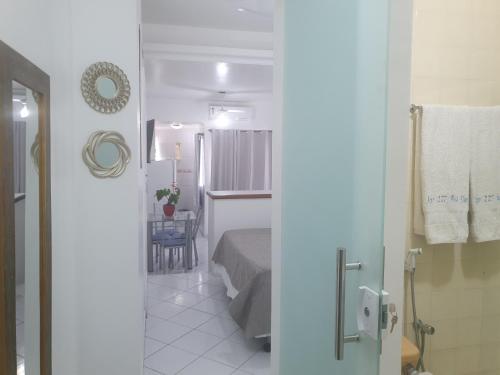 a small room with a bed and a bathroom at Bahia Flat - Flats na Barra in Salvador