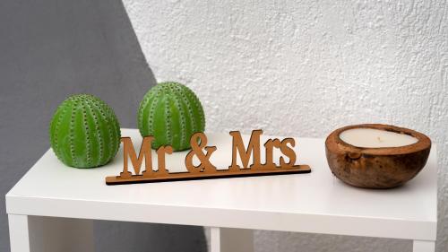 a white table with two cactuses and a candle at 1812 Caves 'n Mansion in Karterados