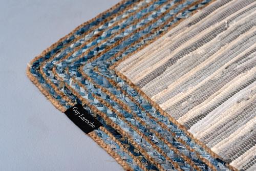 a close up of a crochet blanket with a black tag at 1812 Caves 'n Mansion in Karterados