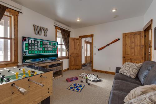 a living room with a tv and a couch at Alpine Airspace by KABINO Airpark Foosball Garage Satellite in Alpine