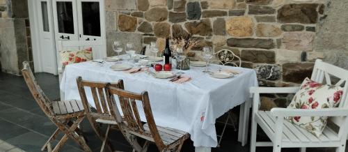 a table with a white table cloth on top of it at Hotel Rural El Secreto de Julia in Ríoseco