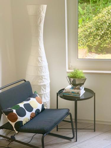 a chair and a table in a room with a window at Ferienwohnung in Bad Segeberg in Bad Segeberg