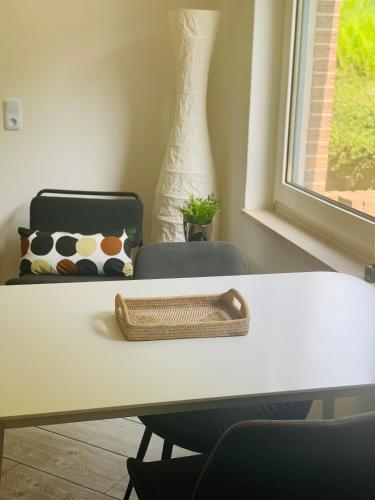 a table with a chair and a pillow and a window at Ferienwohnung in Bad Segeberg in Bad Segeberg