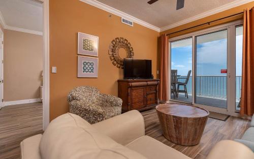 a living room with a couch and a tv at Island Royale 1103 condo in Gulf Shores