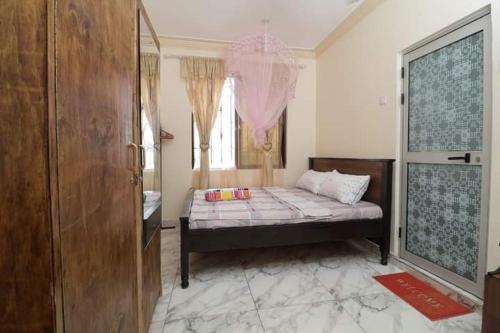 1 dormitorio con cama y ventana grande en Lux Suites Ganjoni Studio Apartment en Mombasa