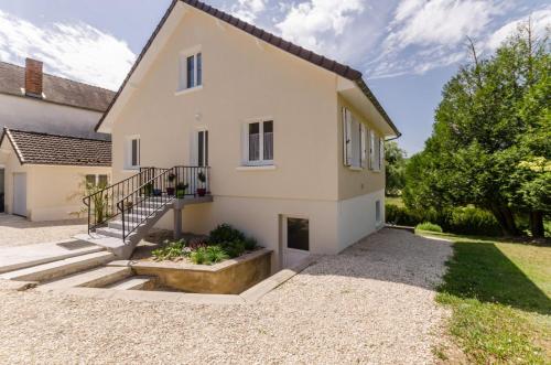 a house with a staircase in front of it at La rose d'henri in Landreville