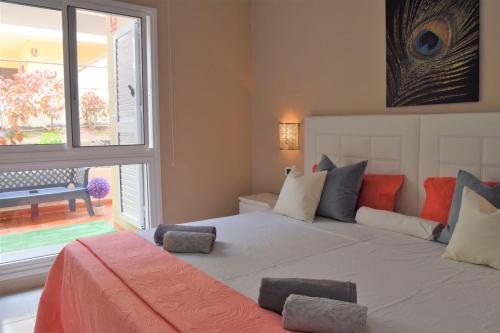 a bedroom with a large bed with a large window at CASA AVVA in San Miguel de Abona