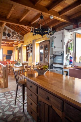 a kitchen with a large wooden island in a room at Casa do Plátano in Cinco Ribeiras