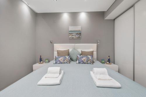 a bedroom with a large bed with two pillows at Renovated Vilamoura Penthouse Near Marina & Beach in Vilamoura