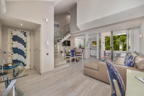 a living room with a couch and a table at Renovated Vilamoura Penthouse Near Marina & Beach in Vilamoura