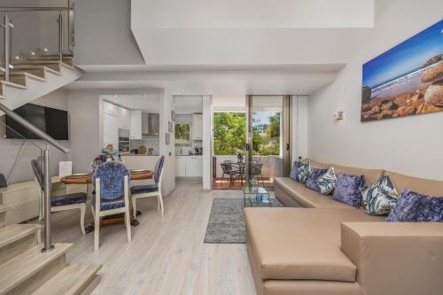 a living room with a couch and a table at Renovated Vilamoura Penthouse Near Marina & Beach in Vilamoura