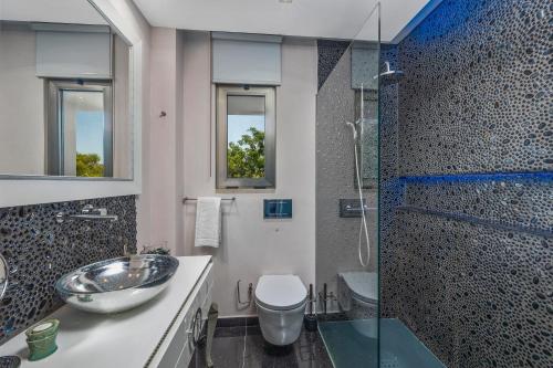 a bathroom with a sink and a shower at Renovated Vilamoura Penthouse Near Marina & Beach in Vilamoura