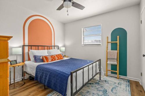 a bedroom with a bed with an arched headboard at Stylish 3BR 2BA House Minutes from PCB - Book now in Panama City