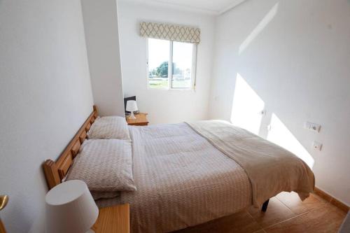 een slaapkamer met een groot bed en een raam bij Casa La Marina spacious apartment 100m in La Marina