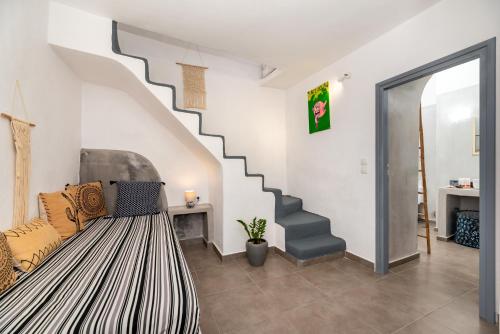a living room with a staircase and a couch at 1812 Caves 'n Mansion in Karterados
