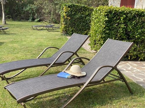 two lawn chairs with a hat sitting on them at Casa Paola in Vesta