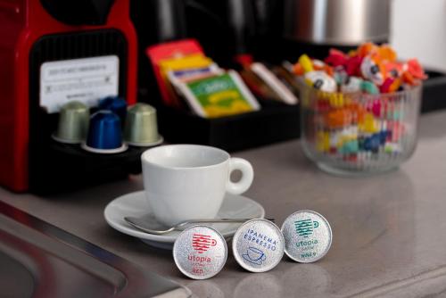 a table with a cup and a saucer and a coffee mug at 1812 Caves 'n Mansion in Karterados