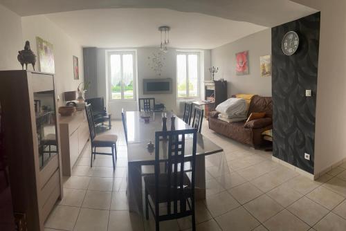 a kitchen and living room with a table and chairs at Au Château Saint Blaise in Virignin