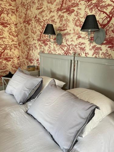 a bedroom with a bed with two pillows on it at Belle Fontaine in Bourges