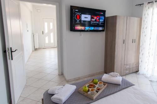 a room with a television and a bowl of fruit at Your Destination in Lixouri