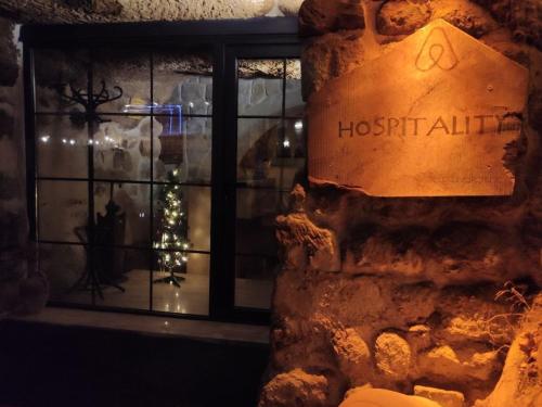a window of a store with a christmas tree in it at Deep Cave House in Urgup