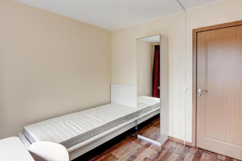 a small room with a bed and a mirror at Smolensko st 13 Vilnius Students Home LT in Vilnius