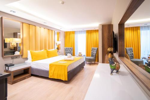 a hotel room with a bed and a living room at Garden Room Suit Hotel in Istanbul