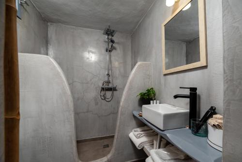 a bathroom with two urinals and a sink at 1812 Caves 'n Mansion in Karterados