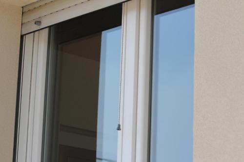 an open window with white curtains on a building at Dimora Due Galli in Ponti Sul Mincio