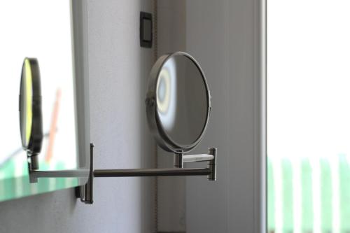 a mirror on a wall next to a window at Dimora Due Galli in Ponti Sul Mincio
