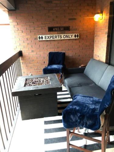 a room with two chairs and a couch on a balcony at 2 Bd/3 Ba, Luxury Ski-in Ski Out Condo - Sleeps 10 in Park City