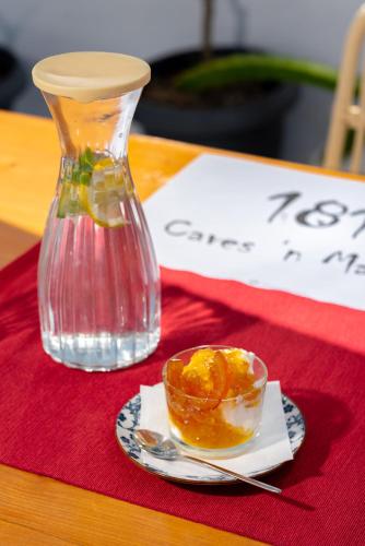 a glass vase and a bowl of fruit on a table at 1812 Caves 'n Mansion in Karterados