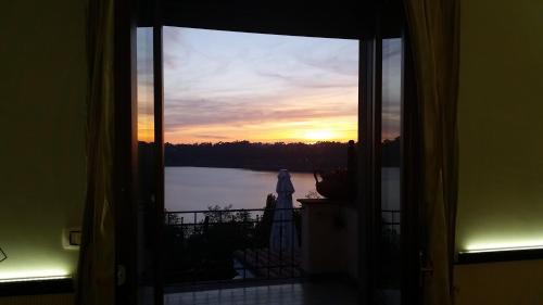 a view of a sunset from a room with a window at Hotel Villa Degli Angeli in Castel Gandolfo