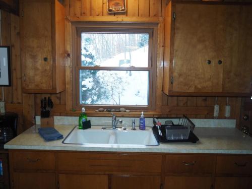 a kitchen sink and a window in a kitchen at The Crystalaire Cabin - Charming And Relaxing! in Frankfort