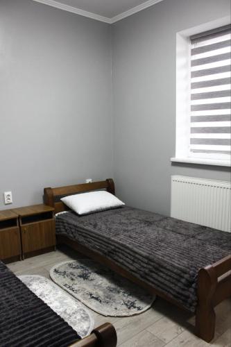 a bedroom with two beds and a window at Margo in Yaremche