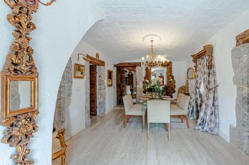 a dining room with a table and a mirror at Masia Mimosa Completa in Darnius