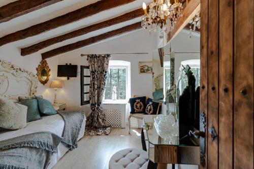 a bedroom with a bed and a table in a room at Masia Mimosa Completa in Darnius
