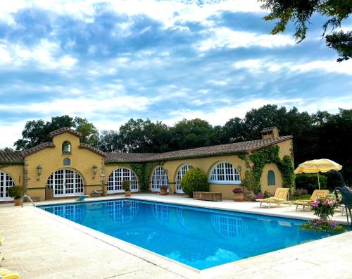 a large swimming pool in front of a house at Masia Mimosa Completa in Darnius