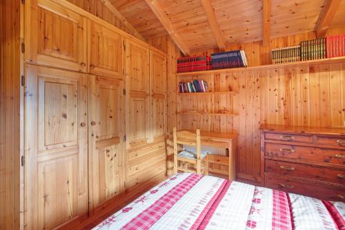 a bedroom with wooden walls and a bed in a cabin at Dolce Casa vicino a Bormio in SantʼAntonio