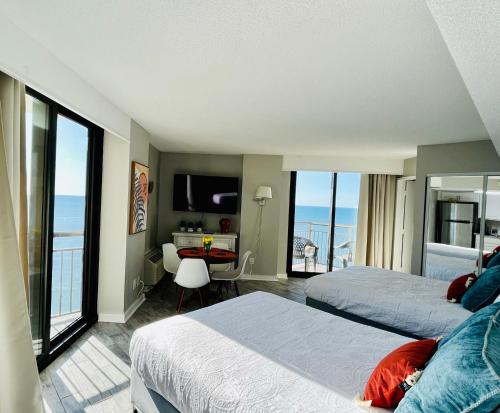 a hotel room with two beds and a view of the ocean at 1726 Ocean View Galore Pet Friendly in Myrtle Beach